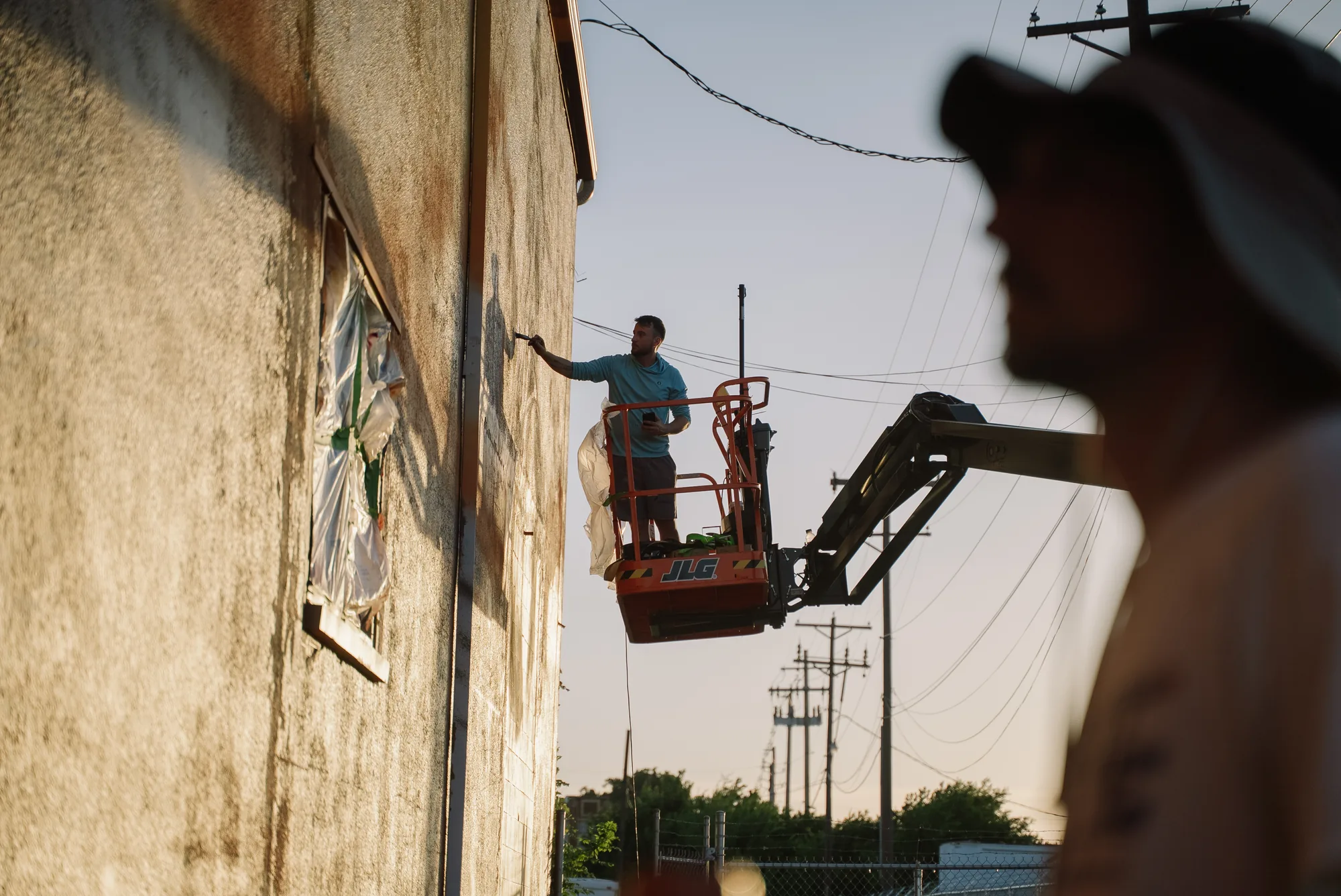 A45 painting a large-scale mural from a lift in Abilene, Texas